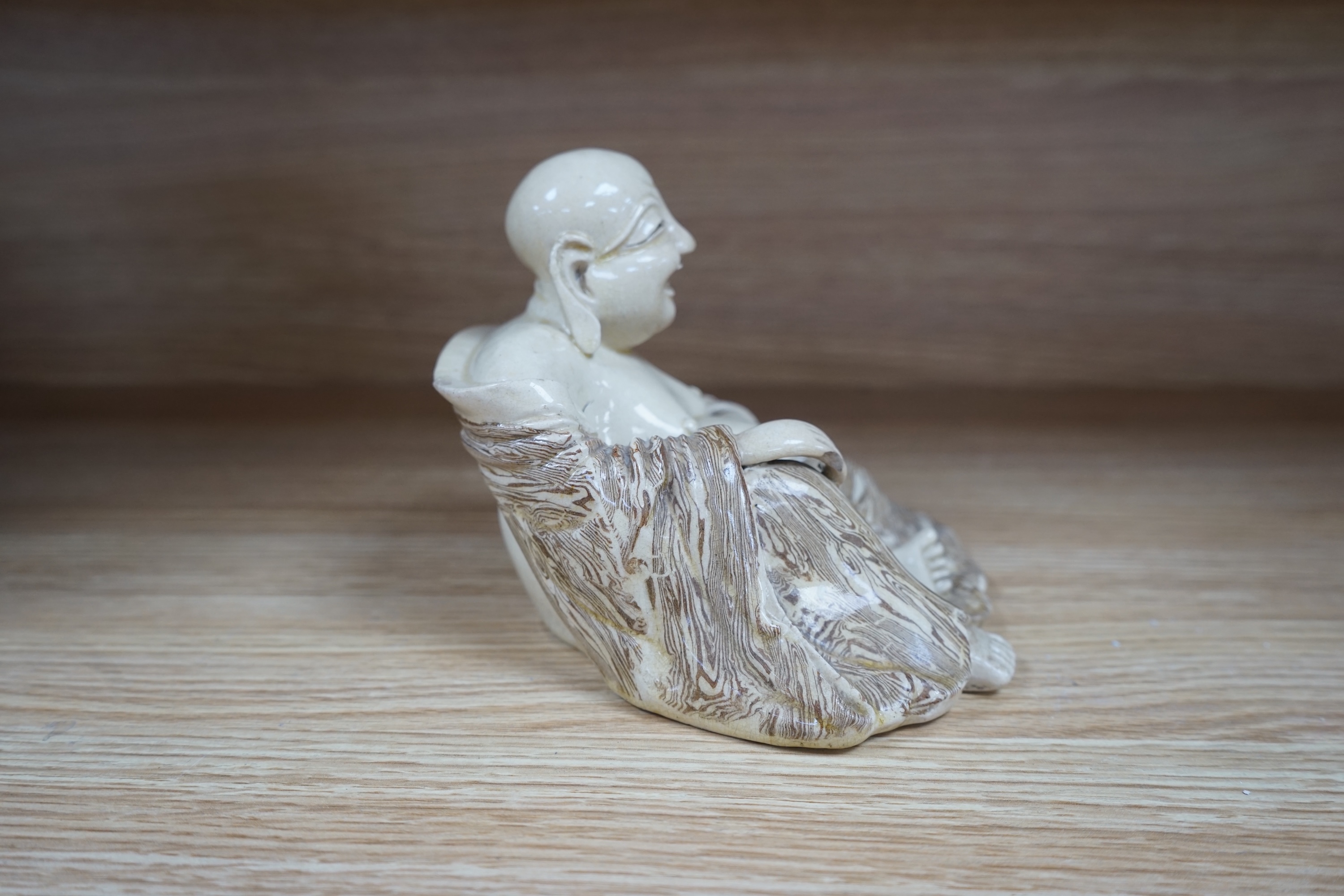 A Chinese marbled pottery figure of Budai, early 20th century, 13cm high. Condition - fair to good.